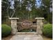 Welcome to Warner Crossing, a private community nestled among mature trees with a stone sign and lush landscaping at 247 Warner Crossing Way, Loris, SC 29569