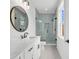 Bathroom featuring white cabinetry, a marble countertop, a glass shower, a toilet and a round mirror at 318 Vista Dr., Murrells Inlet, SC 29576