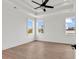 A bright bedroom with hardwood floors, tray ceilings, and ample natural light from the three windows at 318 Vista Dr., Murrells Inlet, SC 29576