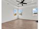 Light and airy bedroom features tray ceilings, wood floors, and shiplap wall at 318 Vista Dr., Murrells Inlet, SC 29576