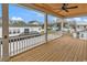 View of deck with ceiling fan, and exterior view of other homes in the neighborhood on a bright day at 318 Vista Dr., Murrells Inlet, SC 29576
