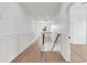 Bright hallway with hardwood floors and a window with an exterior view and stairs leading to the lower level at 318 Vista Dr., Murrells Inlet, SC 29576