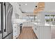 Modern kitchen with white cabinets, a spacious island, stainless steel appliances and stylish pendant lights at 318 Vista Dr., Murrells Inlet, SC 29576