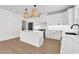 Kitchen features eat-in island, pendant lighting, range and white cabinets at 318 Vista Dr., Murrells Inlet, SC 29576