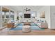 Bright living room with hardwood floors, white walls, and comfortable seating with sliding glass door access to a balcony at 318 Vista Dr., Murrells Inlet, SC 29576