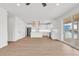 A spacious living space featuring a modern kitchen with white cabinets, stainless steel appliances, and a sliding glass door at 318 Vista Dr., Murrells Inlet, SC 29576