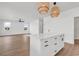 Bright living space showcasing a kitchen with white cabinets, a center island with lighting, and hardwood floors at 318 Vista Dr., Murrells Inlet, SC 29576