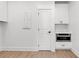 Pantry with white cabinets, stainless steel microwave, laminate floors, and an electrical box on the wall at 318 Vista Dr., Murrells Inlet, SC 29576