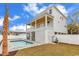 Backyard pool with a brick patio, enclosed by a white fence, and lined with vibrant palm trees at 318 Vista Dr., Murrells Inlet, SC 29576