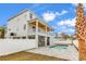 Backyard pool with stone pavers and stair entry surrounded by a privacy fence and palm trees at 318 Vista Dr., Murrells Inlet, SC 29576