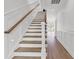 Staircase featuring wood stairs, white risers and walls with wood handrail at 318 Vista Dr., Murrells Inlet, SC 29576