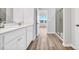 Bright bathroom featuring dual sinks, quartz countertops, modern fixtures, and a glass-enclosed shower at 415 Joseph St, Longs, SC 29568