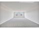 Spacious bonus room with two windows and neutral carpet, perfect for a variety of uses at 415 Joseph St, Longs, SC 29568