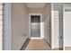 Close up of a front door and entry showing neutral siding and hardware at 415 Joseph St, Longs, SC 29568