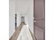 Bright hallway featuring wood-look flooring and a glimpse of natural light at 415 Joseph St, Longs, SC 29568