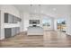 Bright, open kitchen features gray cabinets, granite countertops, stainless appliances, and a central island at 415 Joseph St, Longs, SC 29568