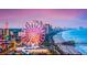 The beach skyline featuring a ferris wheel, ocean, and bright buildings offers a vibrant and exciting view at 4603 Arran Ct. # C, Myrtle Beach, SC 29579