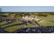 An aerial view of the golf course and manor, displaying pristine greens and a stately clubhouse at 4603 Arran Ct. # C, Myrtle Beach, SC 29579