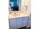 Bathroom vanity with a sink, mirror, and wall-mounted hair dryer with a glimpse into the bedroom at 4603 Arran Ct. # C, Myrtle Beach, SC 29579
