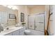 Well-lit bathroom with vanity, toilet, and glass enclosed tub-shower combination at 4603 Arran Ct. # C, Myrtle Beach, SC 29579