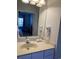 Bathroom vanity with a sink, mirror, and wall-mounted hair dryer with a glimpse into the bedroom at 4603 Arran Ct. # C, Myrtle Beach, SC 29579