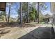 Landscaped backyard featuring a patio area, complemented by tall trees, offering a private retreat at 6454 Sweet Gum Trail, Myrtle Beach, SC 29588