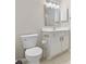 Bathroom featuring a toilet, single sink vanity with a framed mirror, and neutral paint at 6454 Sweet Gum Trail, Myrtle Beach, SC 29588