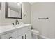 Bathroom featuring a white vanity with a dark faucet and toilet at 6454 Sweet Gum Trail, Myrtle Beach, SC 29588