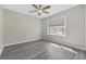 Bedroom with light gray walls, wood-look floors, ceiling fan, and window at 6454 Sweet Gum Trail, Myrtle Beach, SC 29588