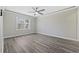 Bedroom with wood-look floors, neutral walls, and a window providing natural light at 6454 Sweet Gum Trail, Myrtle Beach, SC 29588