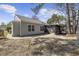 Exterior angle of home featuring an enclosed sunroom and concrete patio at 6454 Sweet Gum Trail, Myrtle Beach, SC 29588