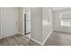 Hallway with stylish flooring leads past a modern refrigerator and entrance doorway at 6454 Sweet Gum Trail, Myrtle Beach, SC 29588