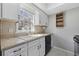 Kitchen features white cabinets, a double basin sink, and a window with natural light at 6454 Sweet Gum Trail, Myrtle Beach, SC 29588
