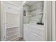 Laundry room featuring white washer and dryer, wire racks for storage, and a door to a bedroom at 6454 Sweet Gum Trail, Myrtle Beach, SC 29588