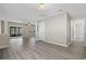 Spacious living room featuring gray vinyl flooring, neutral wall paint, and access to a screened in porch at 6454 Sweet Gum Trail, Myrtle Beach, SC 29588