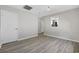 Living room with wood-look floors, neutral walls, and a pass through to the kitchen at 6454 Sweet Gum Trail, Myrtle Beach, SC 29588