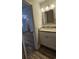 Well-lit bathroom vanity with granite countertop and wood-look vinyl flooring at 703 S 1St Ave. S # 34D, North Myrtle Beach, SC 29582