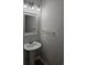 Elegant pedestal sink topped with globe lighting in a modern half-bathroom at 703 S 1St Ave. S # 34D, North Myrtle Beach, SC 29582