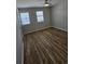 Bedroom with two windows, ceiling fan, and vinyl flooring at 703 S 1St Ave. S # 34D, North Myrtle Beach, SC 29582