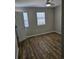 Open bedroom with ceiling fan and wood-look vinyl flooring at 703 S 1St Ave. S # 34D, North Myrtle Beach, SC 29582