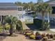 Community view with palm trees, pool, and waterway at 703 S 1St Ave. S # 34D, North Myrtle Beach, SC 29582