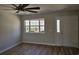 Living room features hardwood flooring, a ceiling fan, and natural light from the front window and door at 703 S 1St Ave. S # 34D, North Myrtle Beach, SC 29582