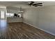 Open living space with wood-look flooring, and view into kitchen with granite countertops and stainless steel appliances at 703 S 1St Ave. S # 34D, North Myrtle Beach, SC 29582