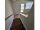 Hallway staircase with wood railing and flooring near an exit door at 703 S 1St Ave. S # 34D, North Myrtle Beach, SC 29582