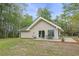 Back of home features a patio with table and chairs, nice backyard and a stone chimney at 1047 Holt Rd., Conway, SC 29526