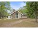Charming home with stone chimney, large windows, and wooded surroundings at 1047 Holt Rd., Conway, SC 29526