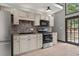 The updated kitchen has stainless steel appliances, a stylish backsplash, granite counters, and ample cabinet space at 1047 Holt Rd., Conway, SC 29526