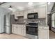 Updated kitchen boasts stainless steel appliances, a stylish backsplash, granite counters, and ample cabinet space at 1047 Holt Rd., Conway, SC 29526