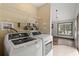 Bright laundry room with GE washer and dryer and ample storage space with a metal rack at 1047 Holt Rd., Conway, SC 29526