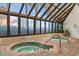 Bright indoor hot tubs under a glass roof, offering a relaxing experience with palm tree views at 1105 Coral Beach Circle # 438, Myrtle Beach, SC 29577